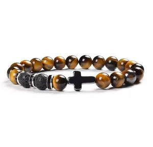Detail view of 8mm yellow tiger eye and lava stone bead bracelet with a black cross charm.