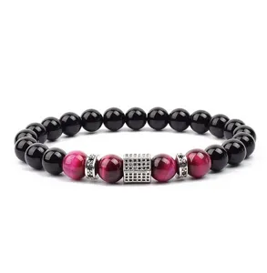 Detailed view of beaded bracelet with red tiger eye stones, black beads and paved cubic zirconia.