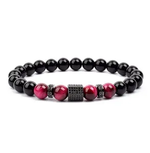 Red tiger eye stone and black bead bracelet detail featuring micro pave zircon charm.