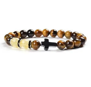 Tiger eye stone and yellow chalcedony beaded bracelet detail view, minimalist black cross.