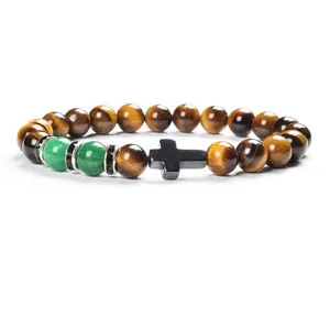 Detailed close-up of tiger's eye, jade and cross beaded bracelet showing fine textures.