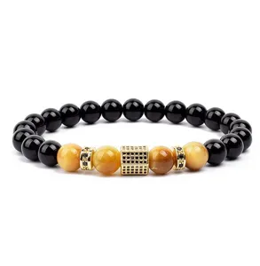 Detail shot of beaded bracelet with black and yellow tiger eye stones and gold micro pave cube.
