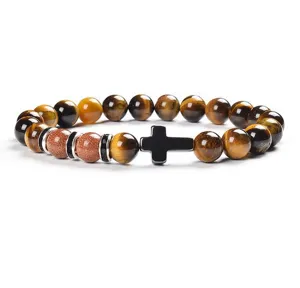 Detail view of the 8mm tiger eye stone beaded bracelet with black cross charm for daily wear.