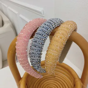 Detailed view of three Baroque beaded headbands in pink, silver, and gold with crystals.