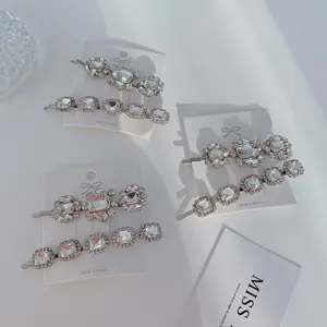 Detailed close-up view of silver-toned rhinestone hair clips with sparkling crystal stones