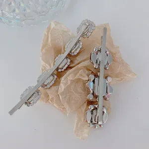 Detailed rear view of two silver alloy hair clips decorated with sparkling white rhinestones