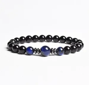 Close-up details of the beaded bracelet featuring black stones and blue tiger eye beads.