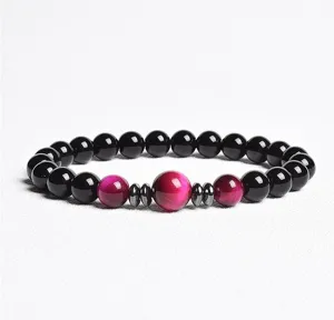 Close-up detail view of gemstone beaded bracelet with black and red tiger eye beads.