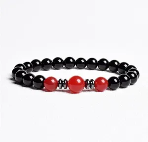 Detailed close-up of the elegant black and red beaded bracelet featuring chic metallic spacers.