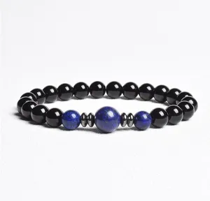 Bead bracelet detail view featuring black and blue polished gemstone beads and metal spacers.