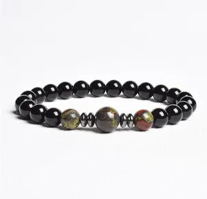 Detailed close-up of natural stone gemstone bracelet with black beads and spacer accents.