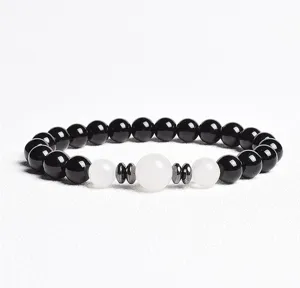 Close-up detail of black and white beaded bracelet with metal spacers for stylish daily wear.