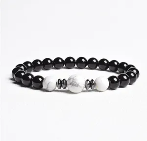 Detailed view of a stylish black and white beaded bracelet with metallic spacer discs.