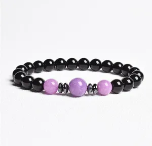 Detail view of an 8mm black and purple beaded bracelet with metallic spacers for daily wear.