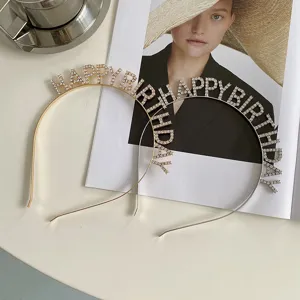 Close-up view of elegant gold and silver rhinestone Happy Birthday letter headbands.