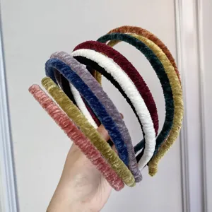 Detail shot of colorful pleated velvet thin headbands showing soft texture and variety.
