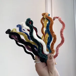 Close-up of colorful velvet wavy headbands showcasing texture and variety.