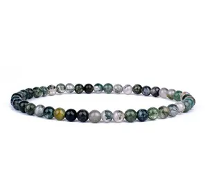 Detailed view of natural green moss agate gemstone round beads bracelet, smooth finish texture.