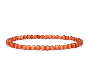 Detail view of 4mm orange cat eye stone round beads bracelet, smooth polished finish.