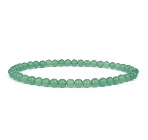 Green gemstone beaded bracelet detail close up, elegant 4mm round beads jewelry item for women.
