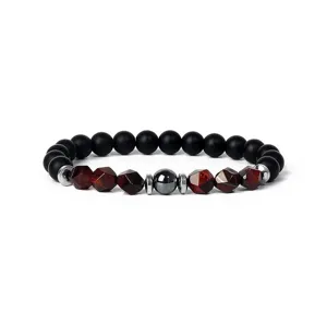 Closeup of 8mm matte black and red faceted stone beaded bracelet with metallic accents