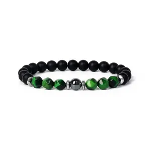 Detailed close-up view of the beaded bracelet with green tiger eye and black stones.