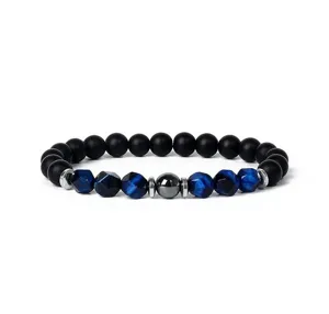 Close-up detail of blue faceted tiger eye and black matte bead bracelet with metal spacers.
