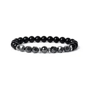 Close-up detail of the black beaded bracelet featuring faceted hematite and round stone beads.