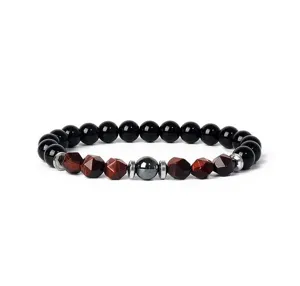 Detailed view of a natural 8mm faceted tiger eye and black stone beaded stretch bracelet.