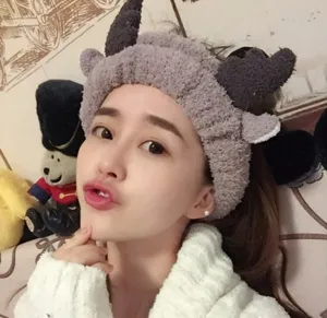 Close-up of a cute plush deer antler headband worn by an Asian female model