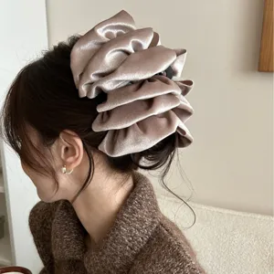 Elegant champagne velvet fluffy bow hair claw clip for women's elegant updo hairstyles.