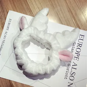 Soft white plush headband with cute pink ears and wings for makeup and skin care
