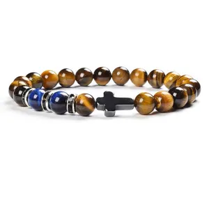 Tiger eye stone and blue chalcedony beaded bracelet with cross charm detail view.