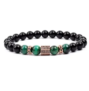 Close-up of stylish beaded bracelet featuring black beads, green tiger eye, and cubic zirconia.