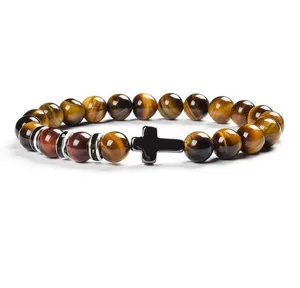 Detailed close-up shot of the 8mm natural tiger eye stone bracelet featuring a sleek black cross.