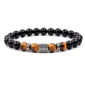 Natural stone tiger eye and black bead bracelet with micro-paved cubic zirconia metal charm.