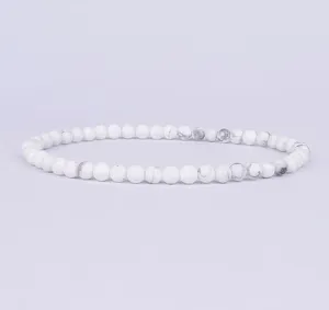 Detailed close-up view of 4mm white stone bead stretch bracelet, elegant minimalist style.
