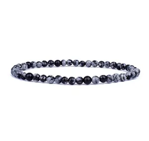 Detailed view of a natural stone bead bracelet featuring black and grey patterned round beads.