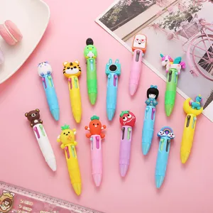 Close-up flatlay of cute cartoon multi-color ballpoint pens featuring adorable animal designs.