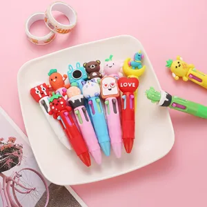Close-up shot showing cute multi-color cartoon ballpoint pens arranged neatly on plate.