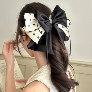 Pince à cheveux élégante avec grand nœud à pois noir et blanc pour chignons