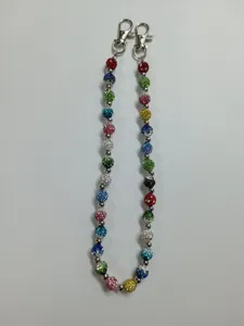 Colorful rhinestone crystal ball chain detail, vibrant sparkly beads close-up view.