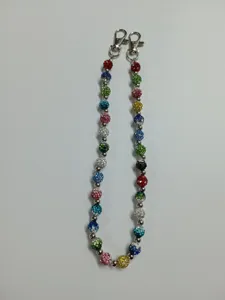 Close-up detail of colorful rhinestone shamballa bead chain with metal lobster clasps.