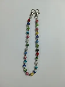 Detailed view of colorful rhinestone disco ball chain with metal lobster clasps for bags.