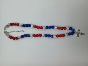 Detailed view of red white and blue Shamballa beads with a sparkling rhinestone cross pendant.