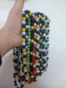 Close-up view of colorful 10mm rhinestone Shamballa beads necklaces held in a hand display
