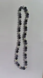 Close-up detail of 10mm purple and black Shamballa clay disco ball bead necklace.
