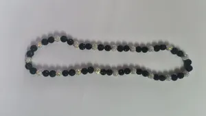 Detailed view of 10mm AB clay disco ball beads on an elastic Shambhala necklace bracelet.