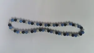 Close-up view of 10mm rhinestone Shamballa beads in blue, black and silver AB tones