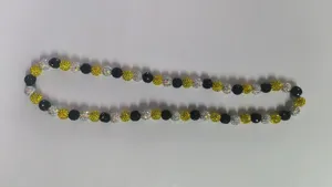 Close-up of 10mm Shamballa rhinestone clay beads in black, gold, and silver colors